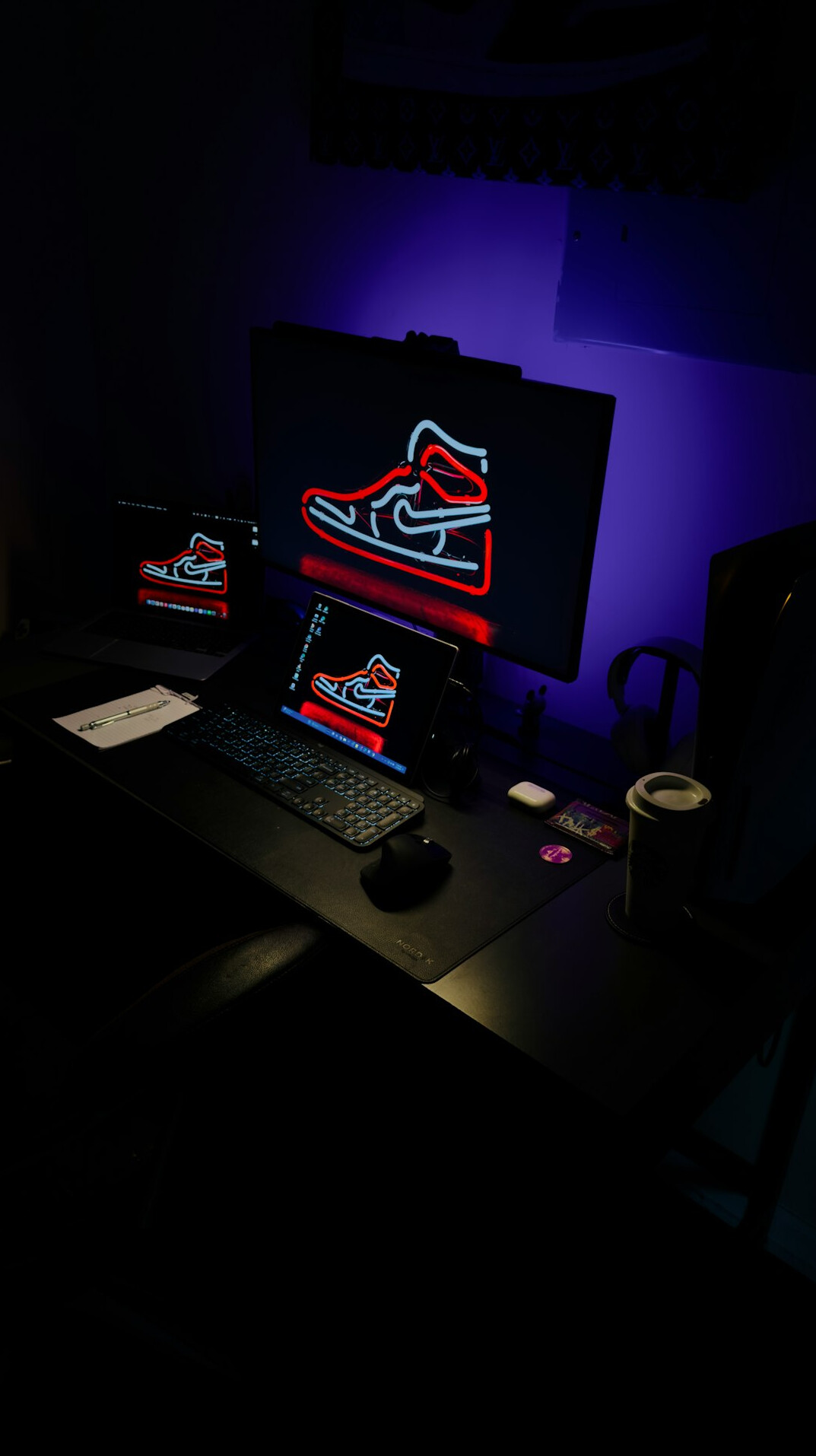 Laptop and code editor on a dark desk setup